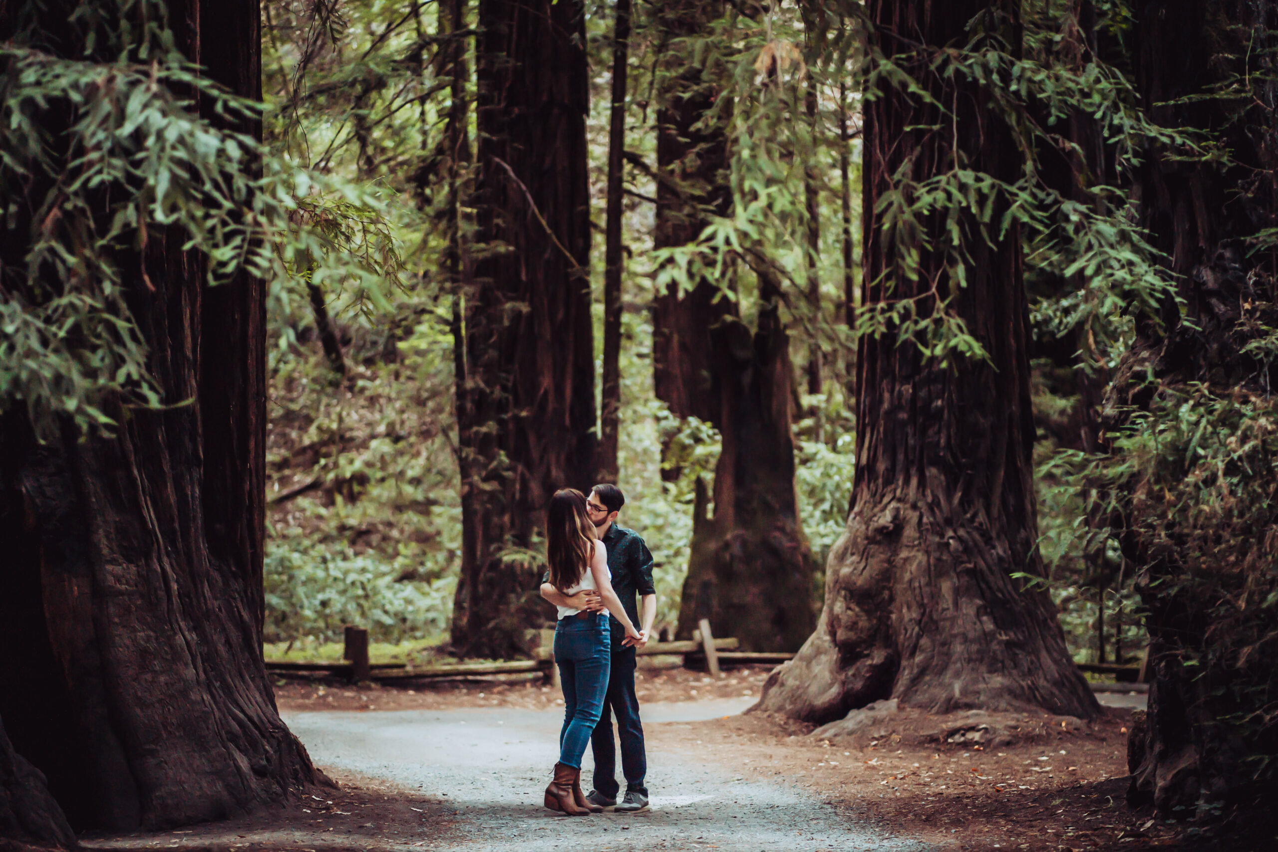 a couple walking in the giant redwoods in Northern California for thier mini moon