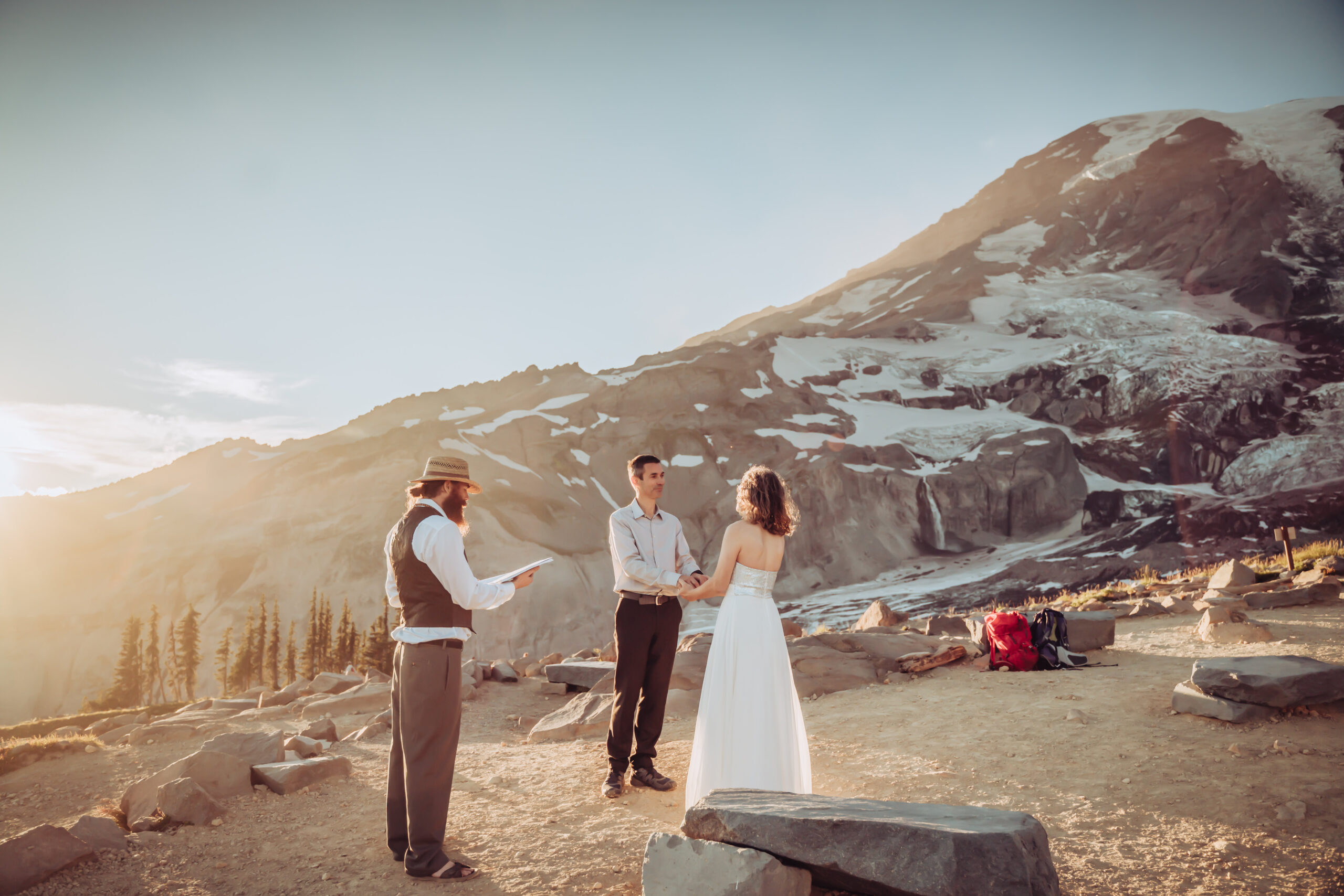 A elopement ceremony during sunset overlooking Mount Rainier