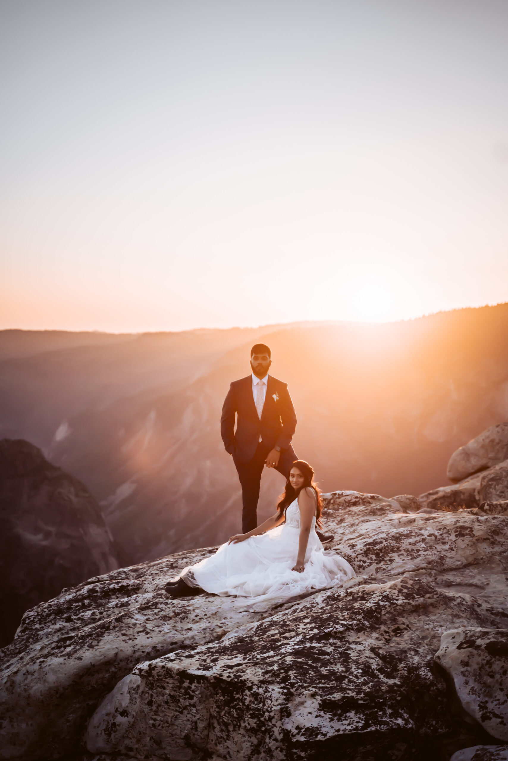 A elopement couple sitting on the rocks at sunset during their Yosemite Elopement