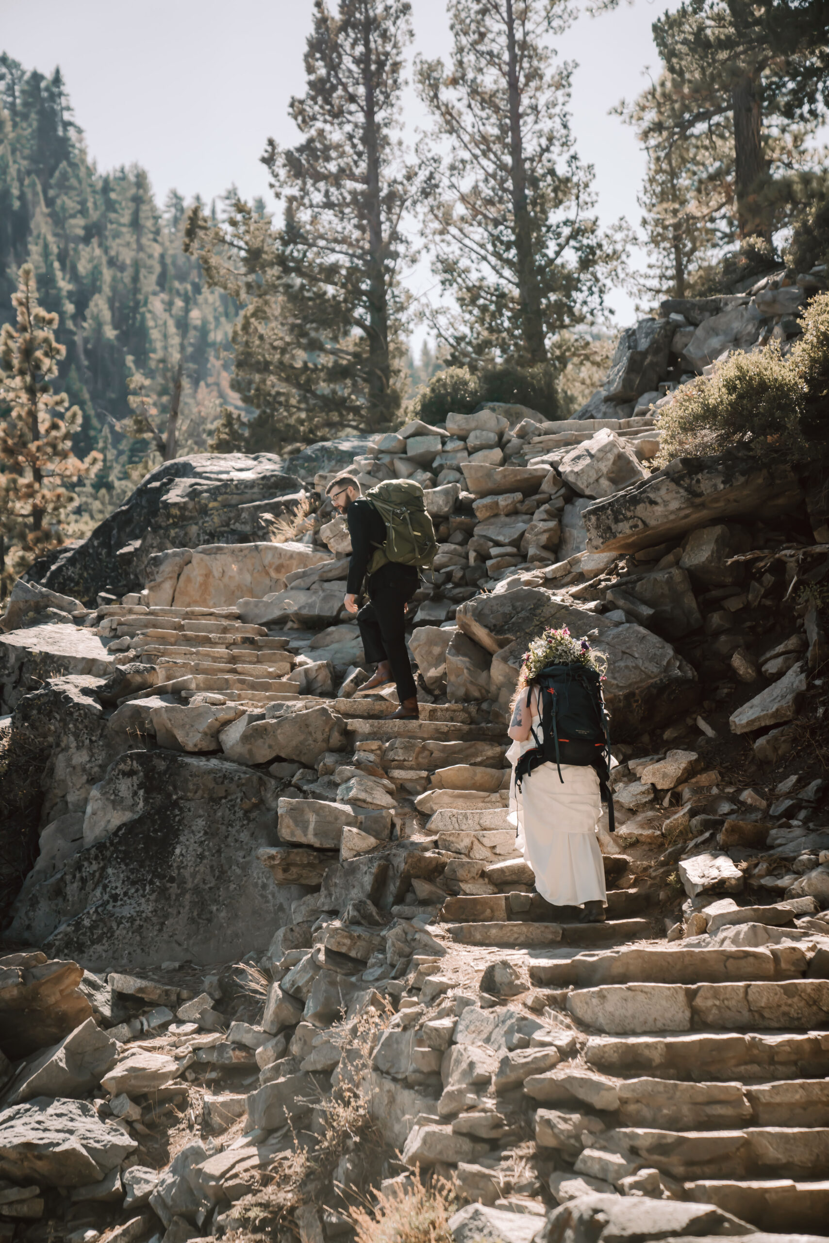 a wedding couple hiking in their wedding clothes for their Elopement