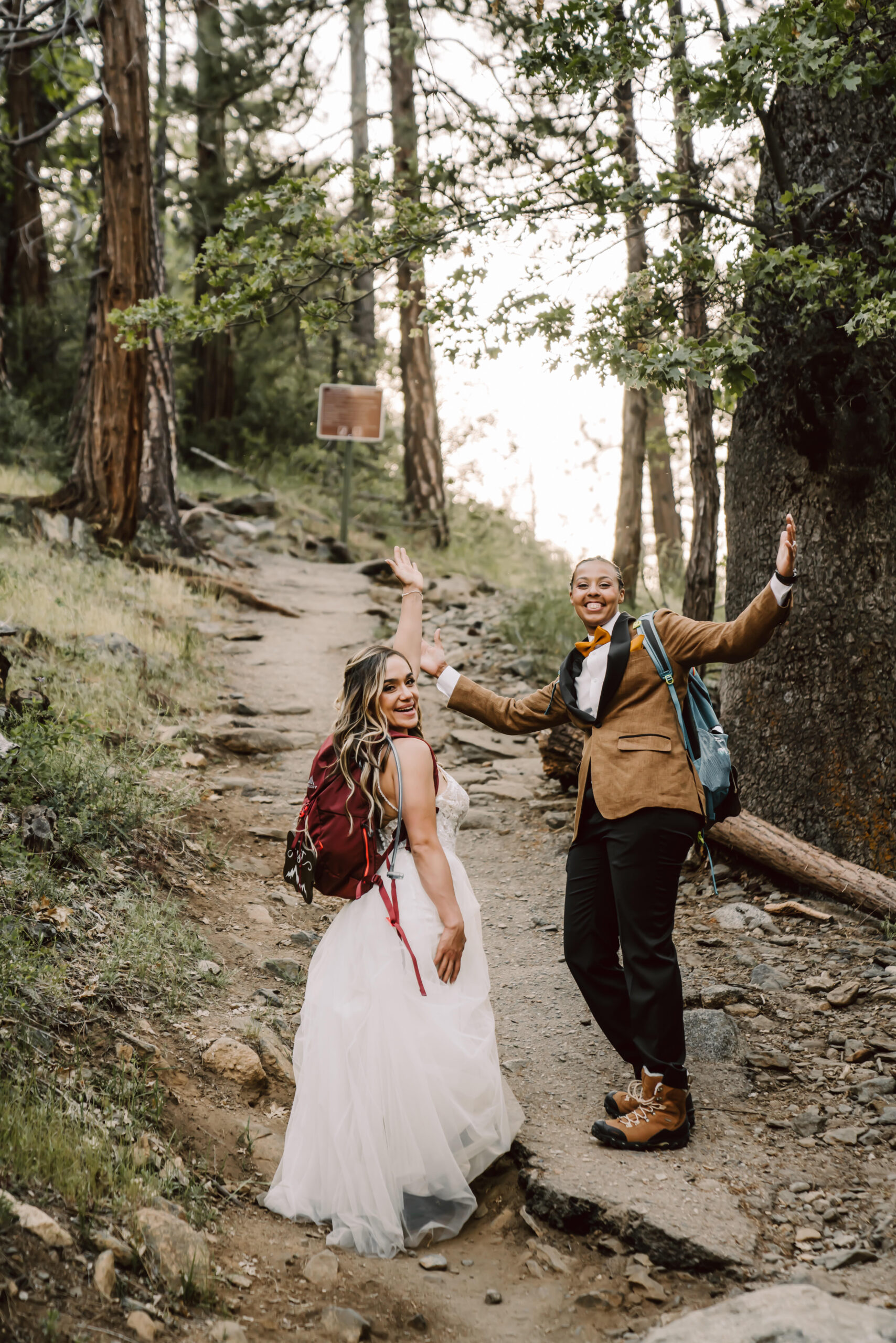 A wedding couple hiking in their wedding clothes for their Elopement day in the mountains