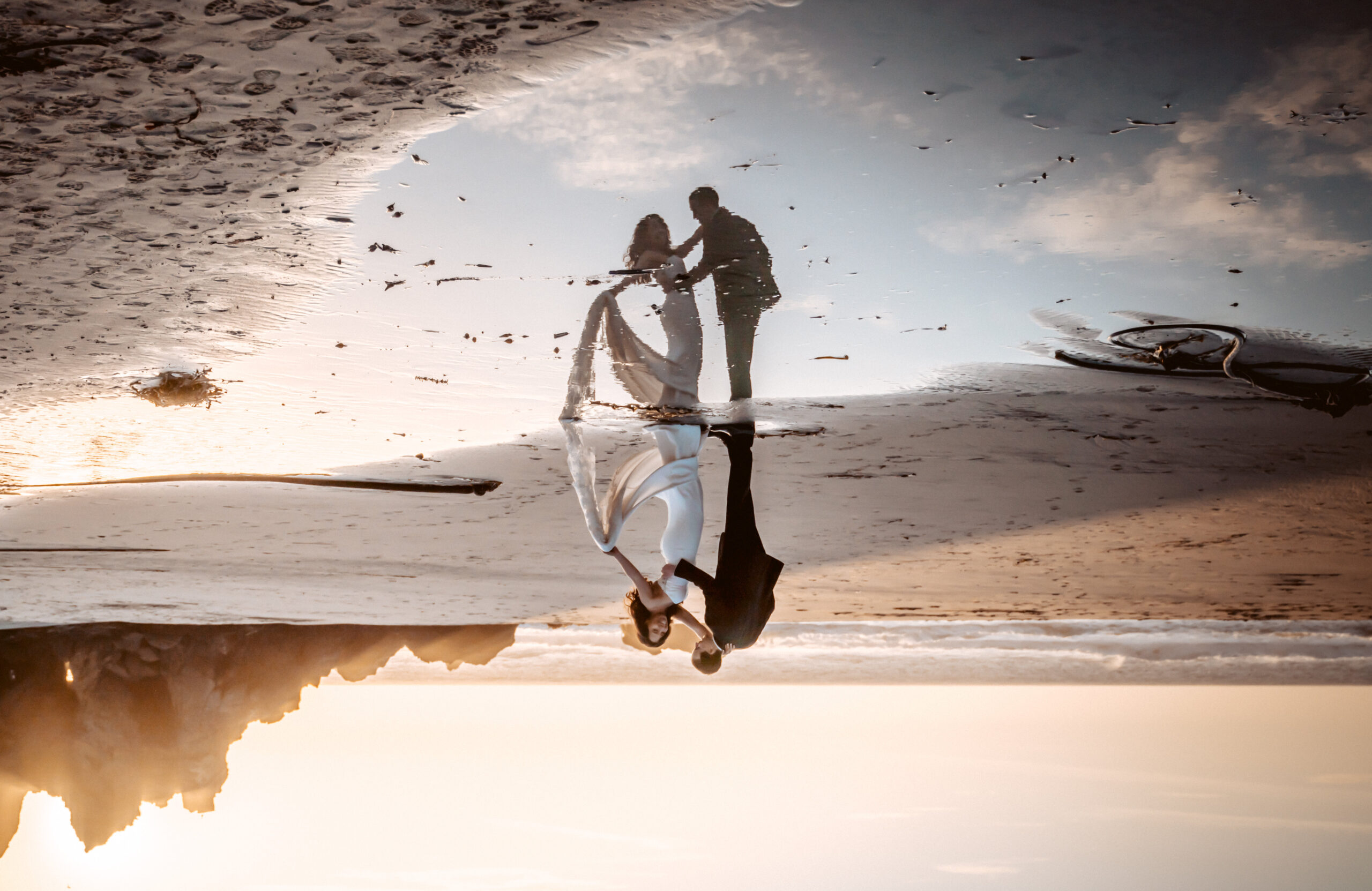 bride and groom dancing in the reflection on the beach in Big Sur for their elopement