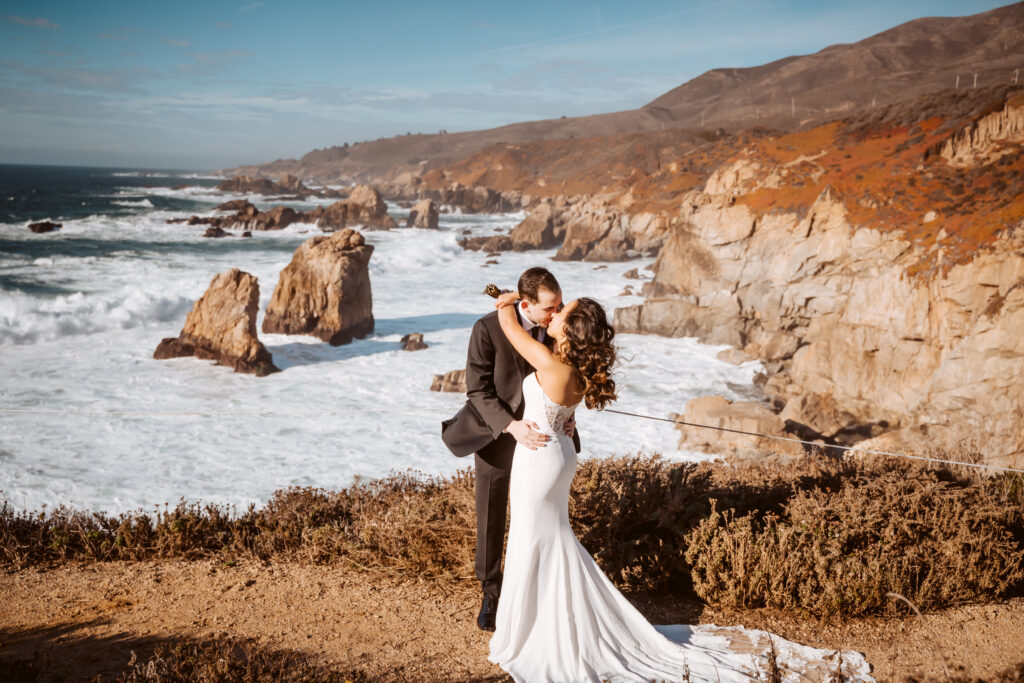 A bride and groom dancing on the cliffs of Big Sur overlooking the ocean