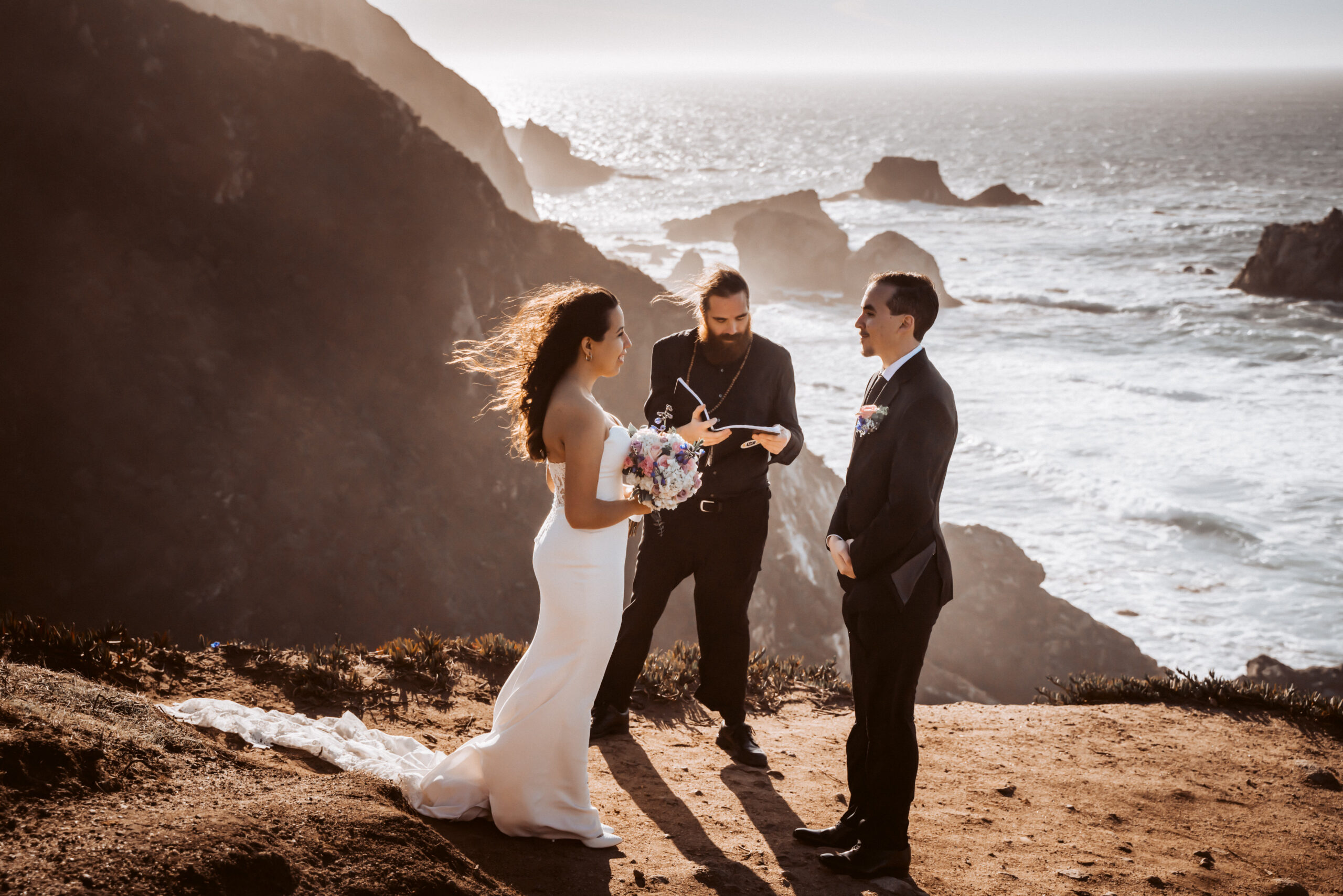 a couple doing a wedding ceremony overlooking the cliffs of Big Sur in California