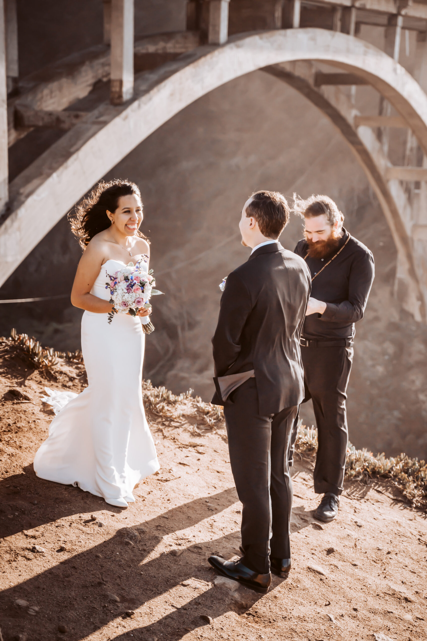a couple doing an elopement ceremony in Big Sur with the iconic bridge in the background