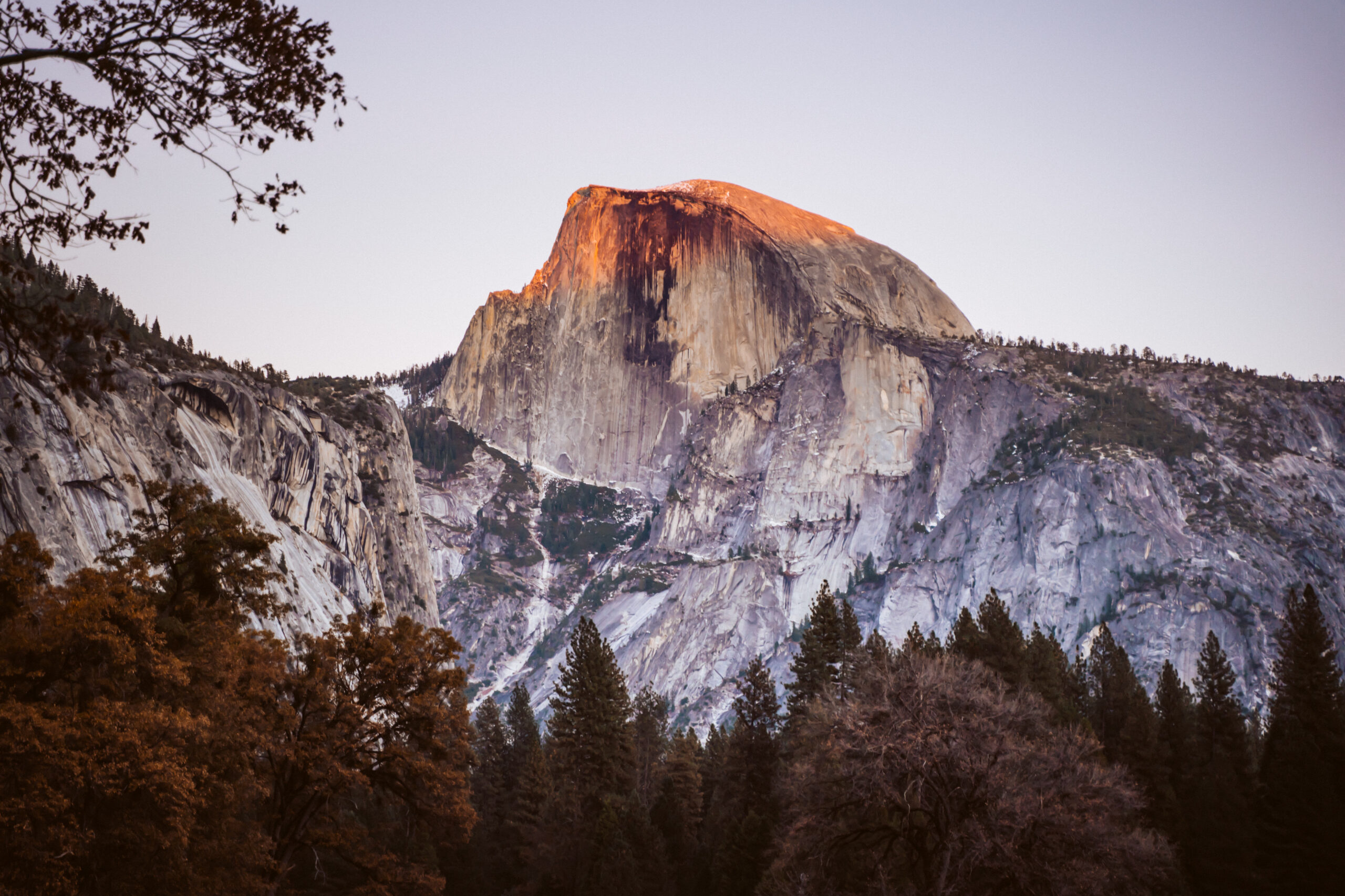a picture of half dome lite up by alpenglow in Yosemite National Park
