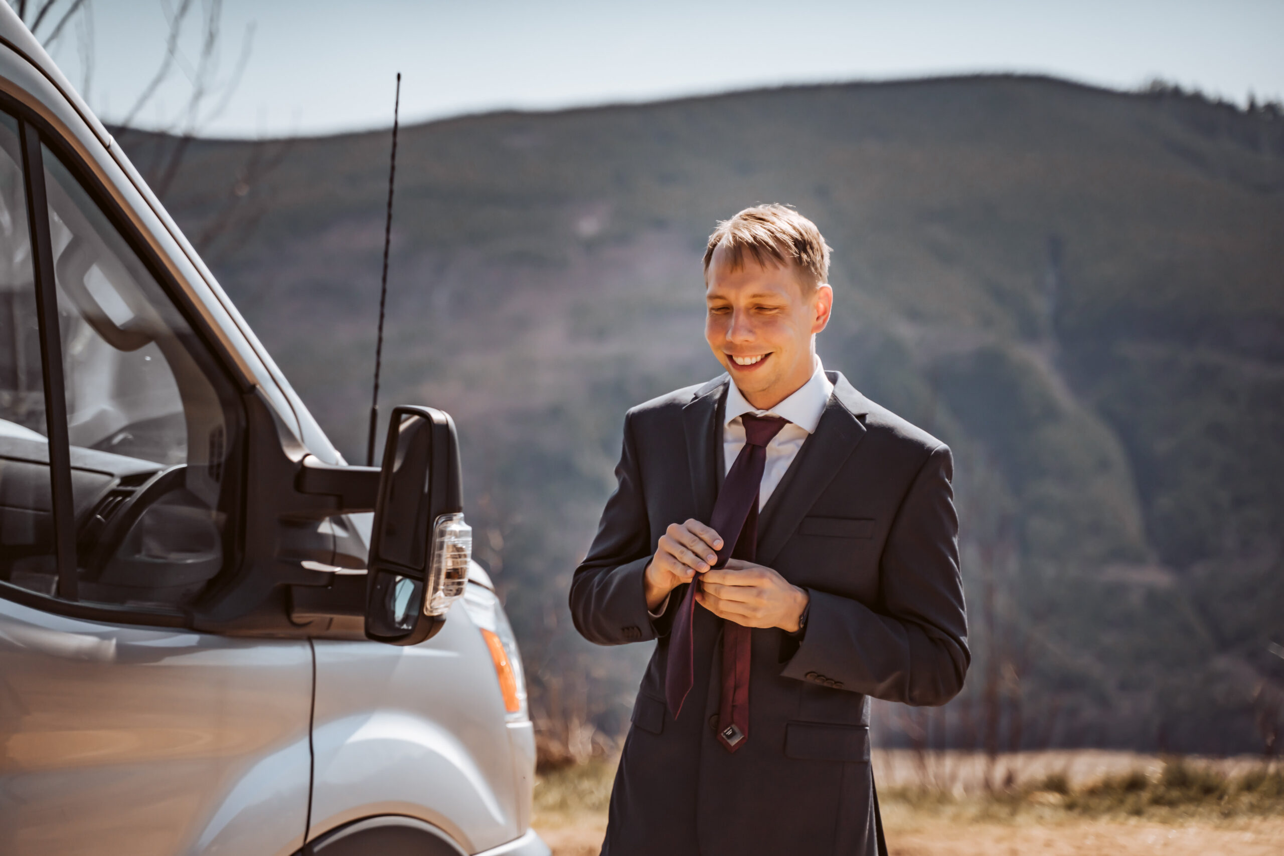  a groom getting ready outside his sprinter van for his mount saint helens elopement