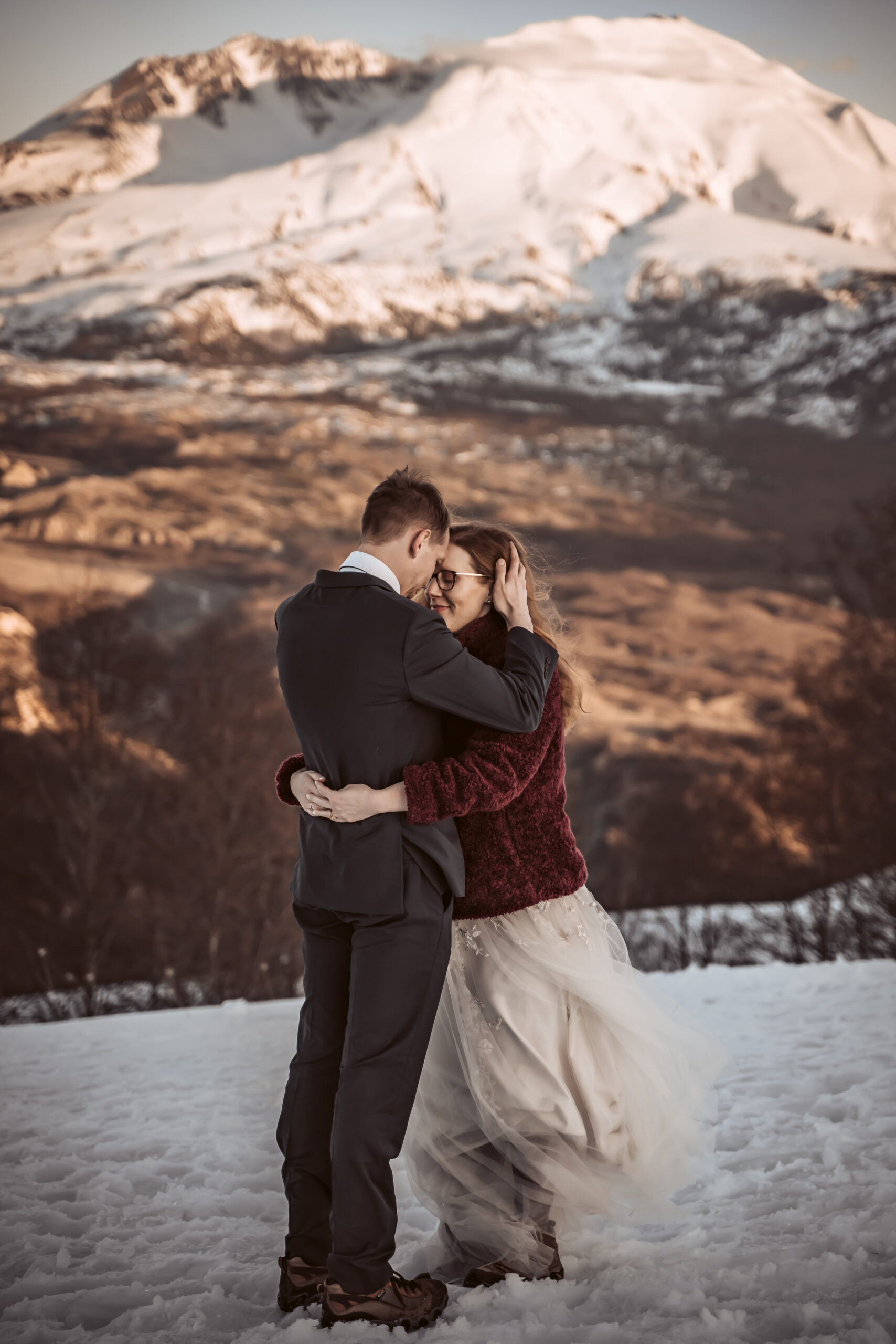 a couple holding each other in front of Mount Saint Helens for their wedding day 