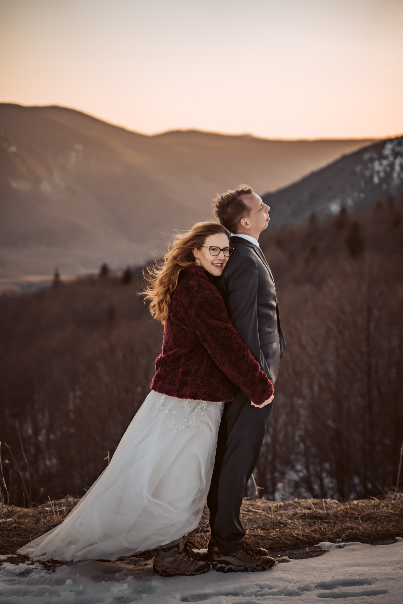  a bride holding her groom in the sunset in the mountains for their elopement day