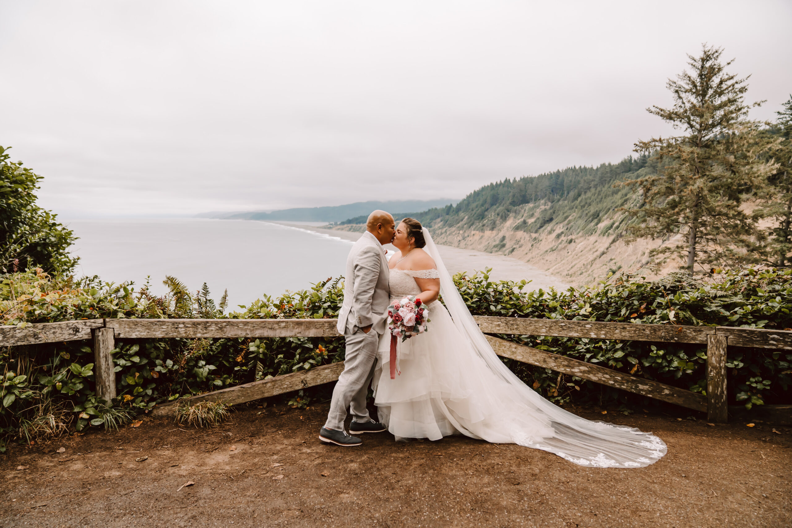 Bride and groom kissing overlooking the north coast of California for their elopement day 