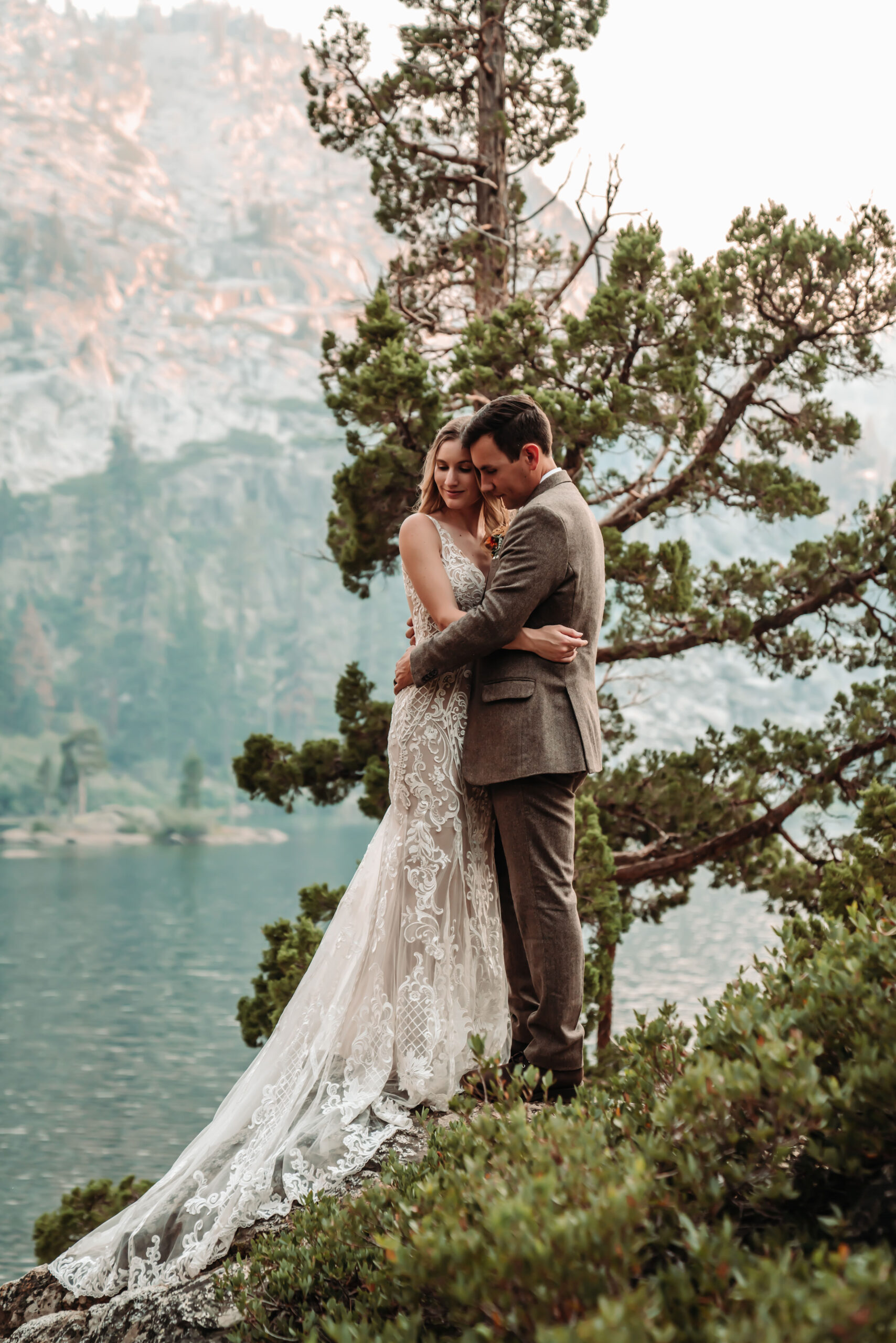 A bride and groom hugging in front of a tree during their Lake Tahoe Elopement 