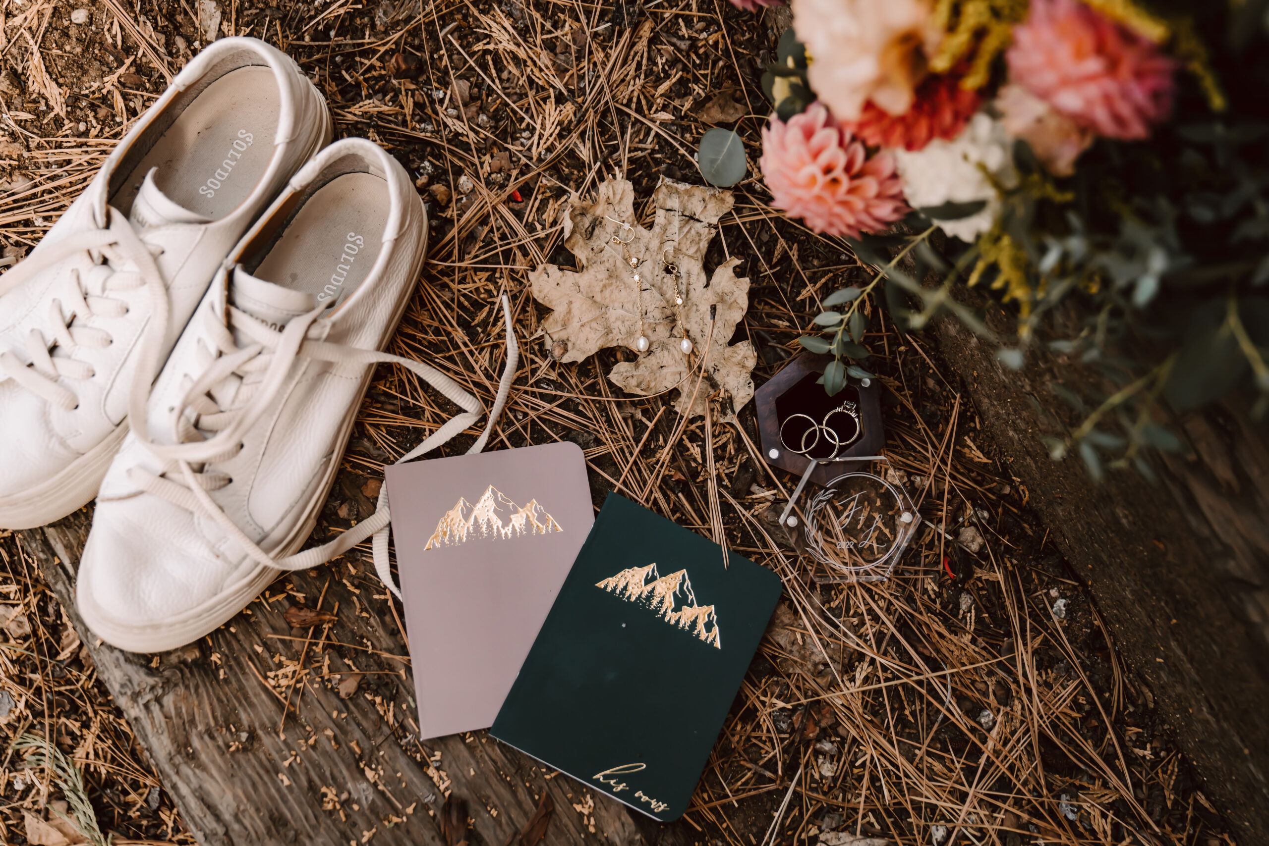 elopement details like rings, vow books, bouquet and hiking boots