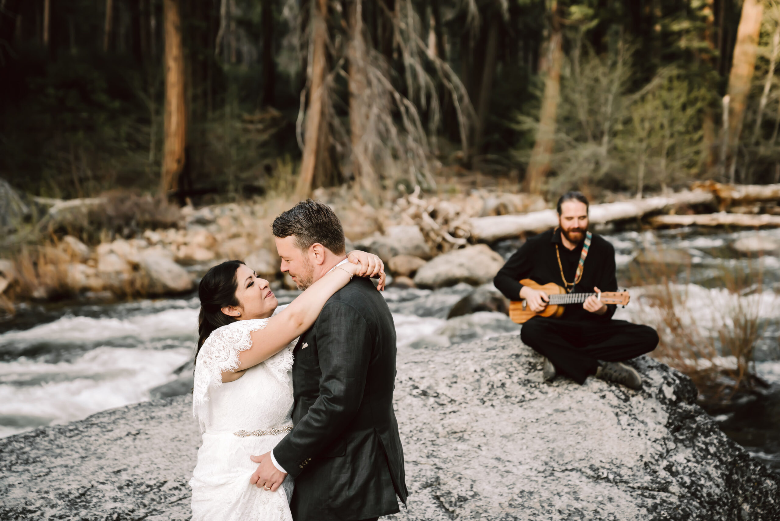 A couple dancing next to the river for their first dance on their elopement day