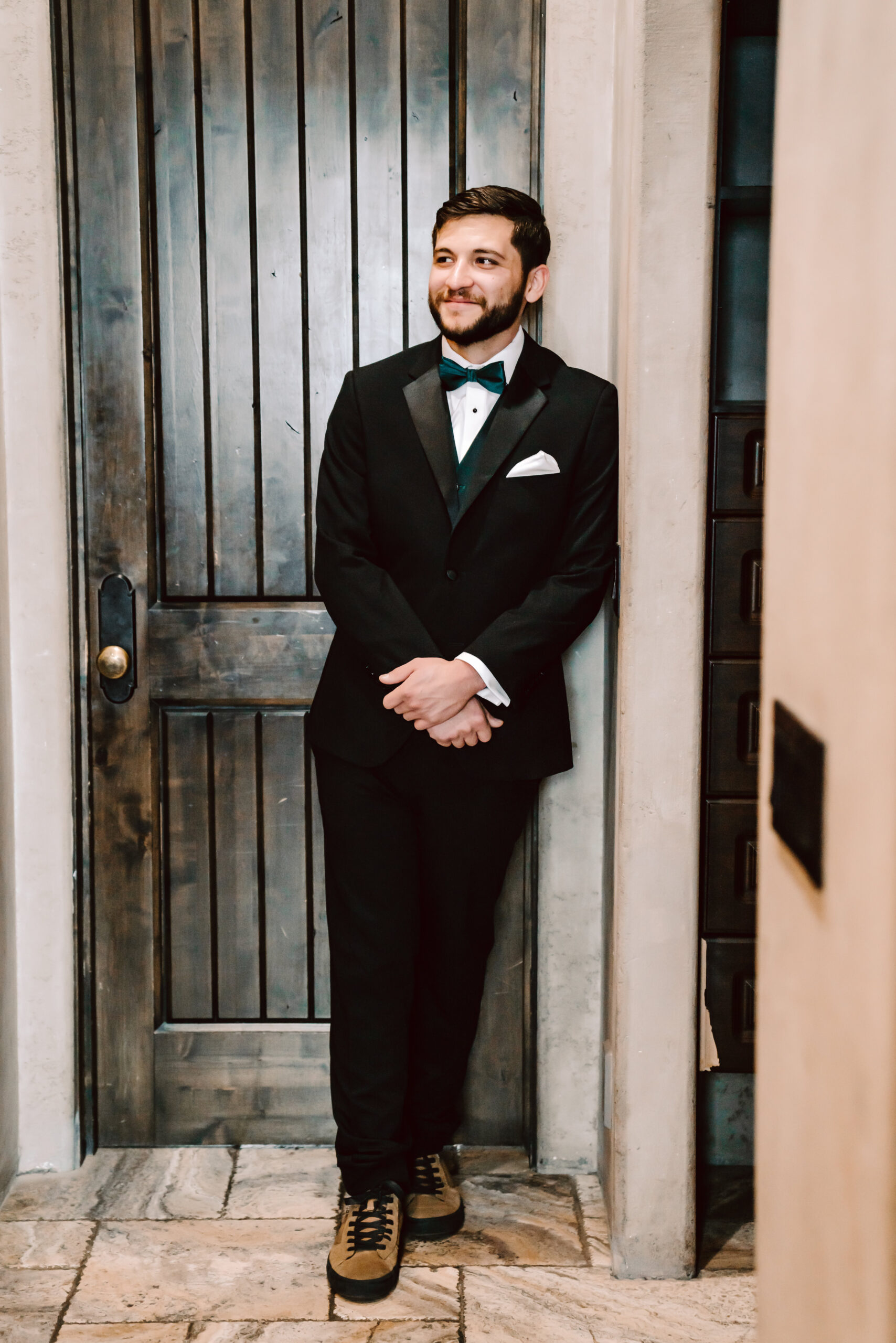 A groom in a traditional black tux