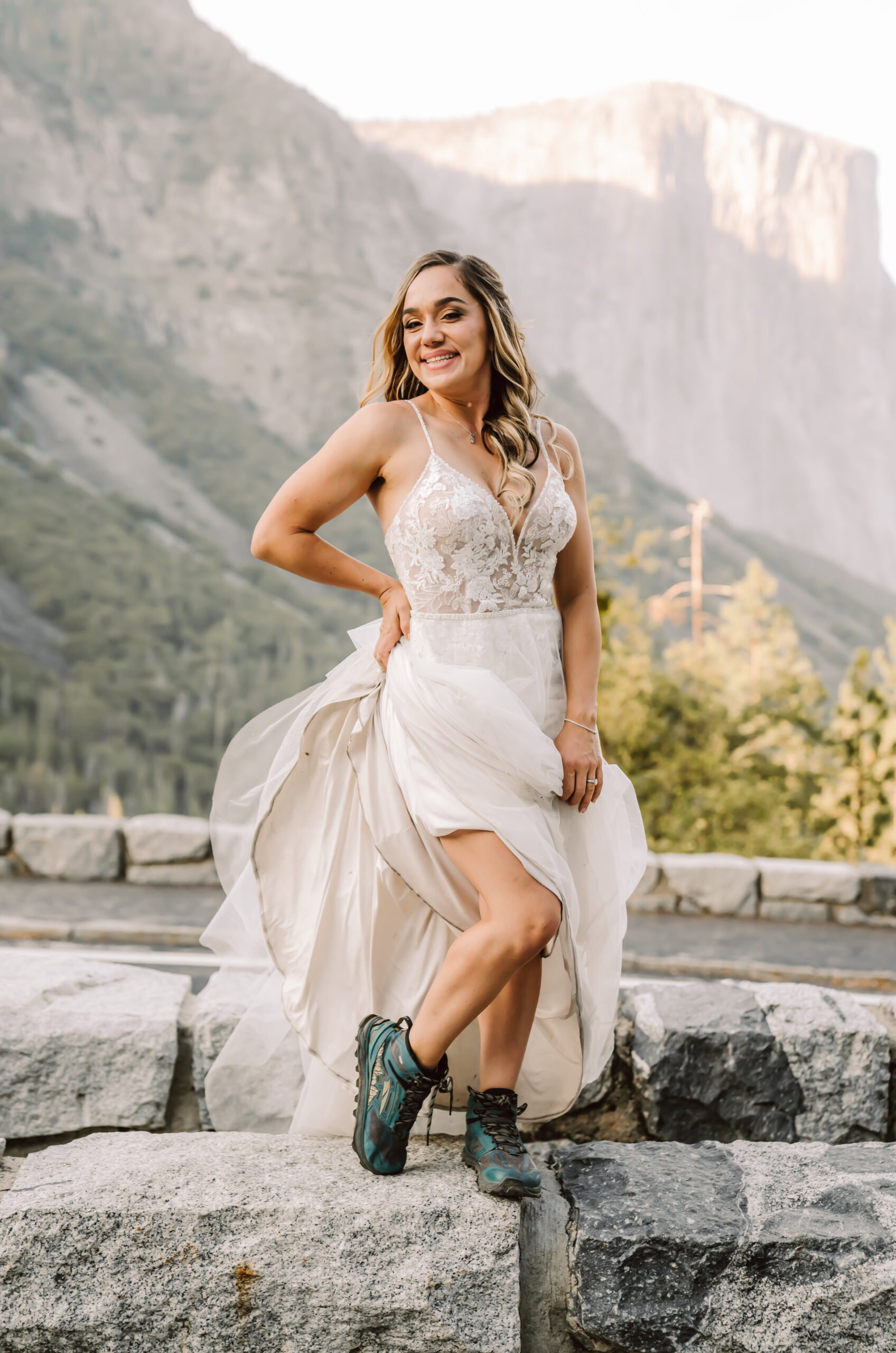 A bride showing her hiking shoes in her elopement dress in Yosemite