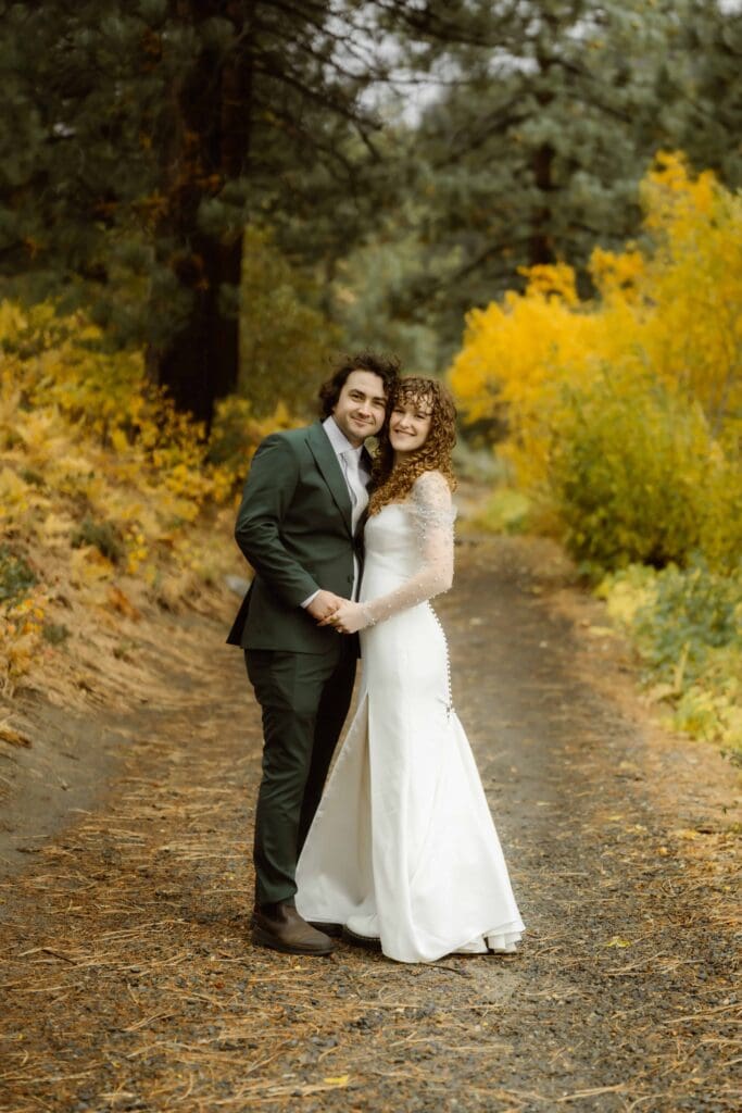 Lake Tahoe fall elopement couple standing together among golden autumn leaves