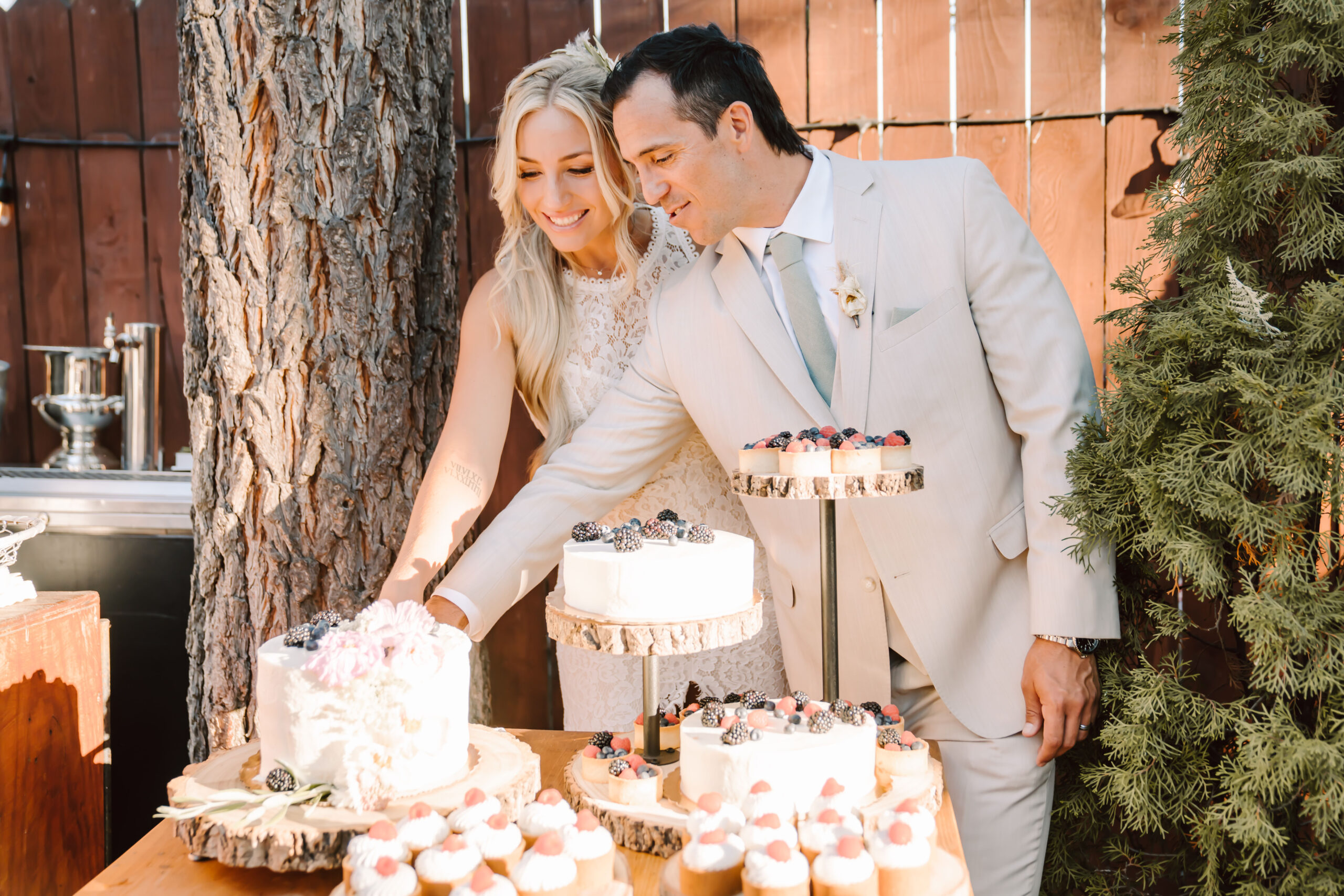 A bride and groom cutting their cake at their wedding reception at the Lakeview Social in Lake Tahoe