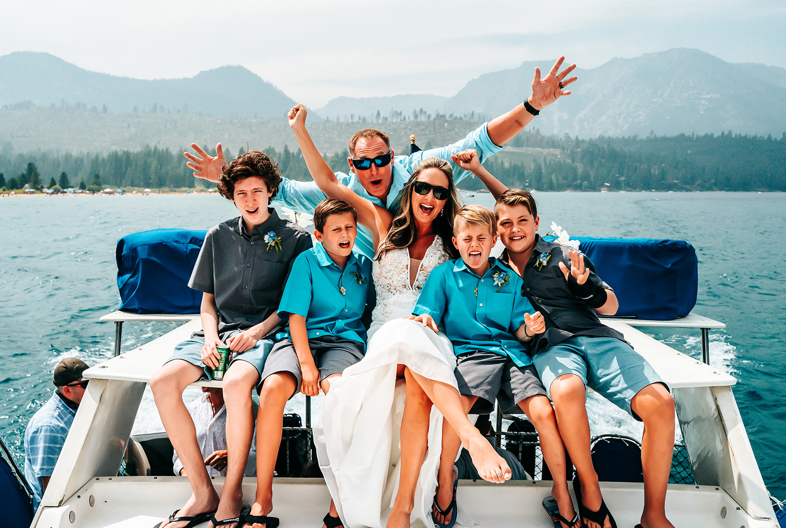 A bride and groom with her kids on a party boat for her wedding