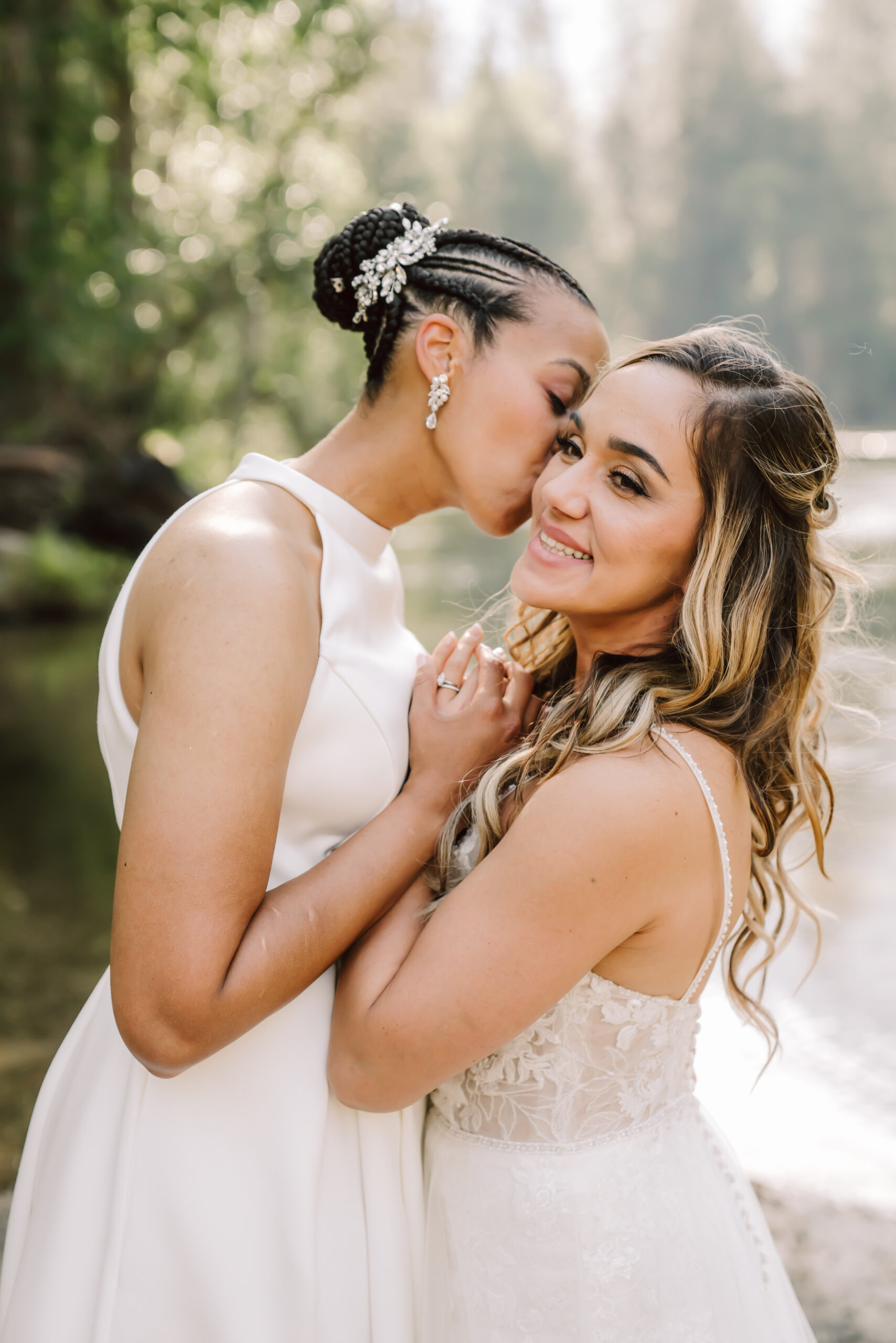 one bride kissing her other bride and holding hand on their Elopement day