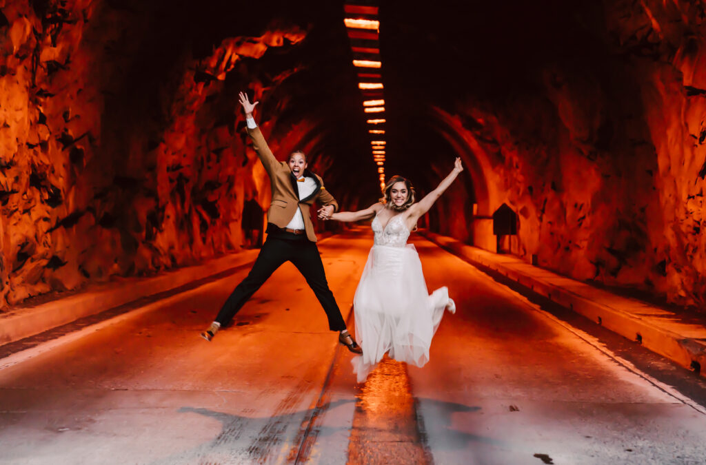 two brides jumping in the tunnel at tunnel view in Yosemite Valley for their elopement day 