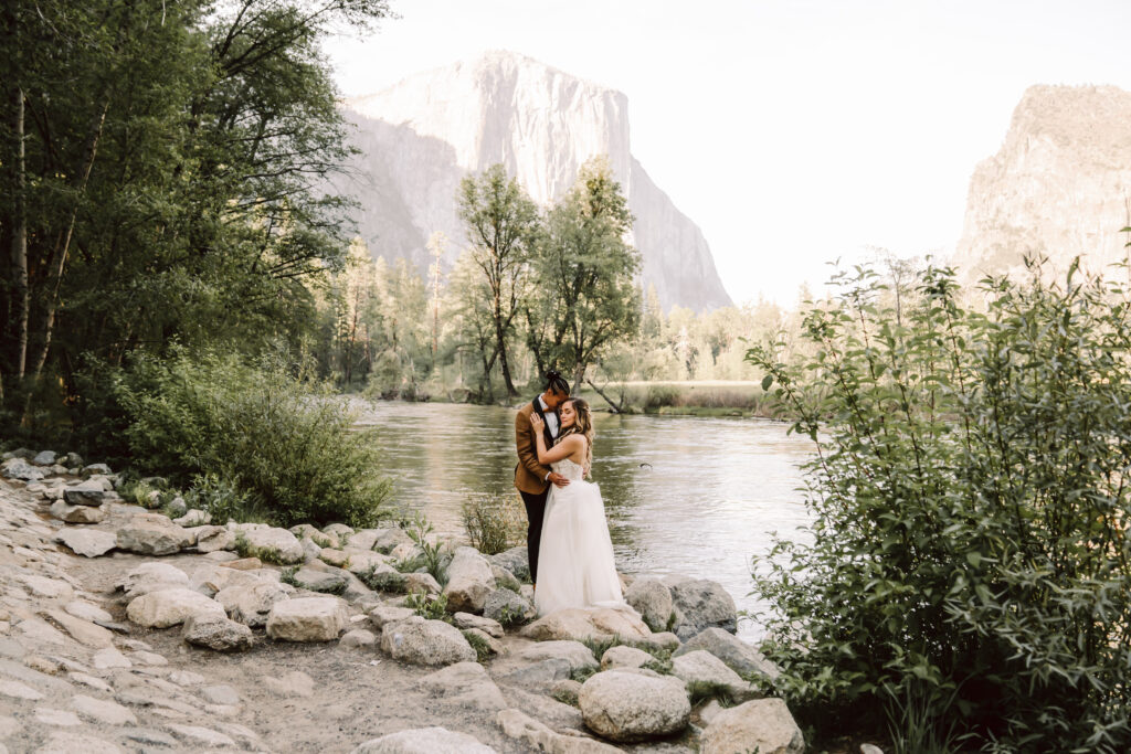 two brides hugging at yosemite Valley View during their Elopement day