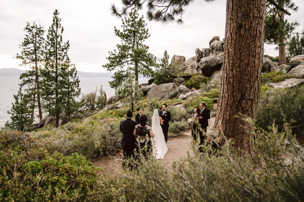 A small wedding ceremony in the trees in Lake Tahoe with the lake in the backdrop