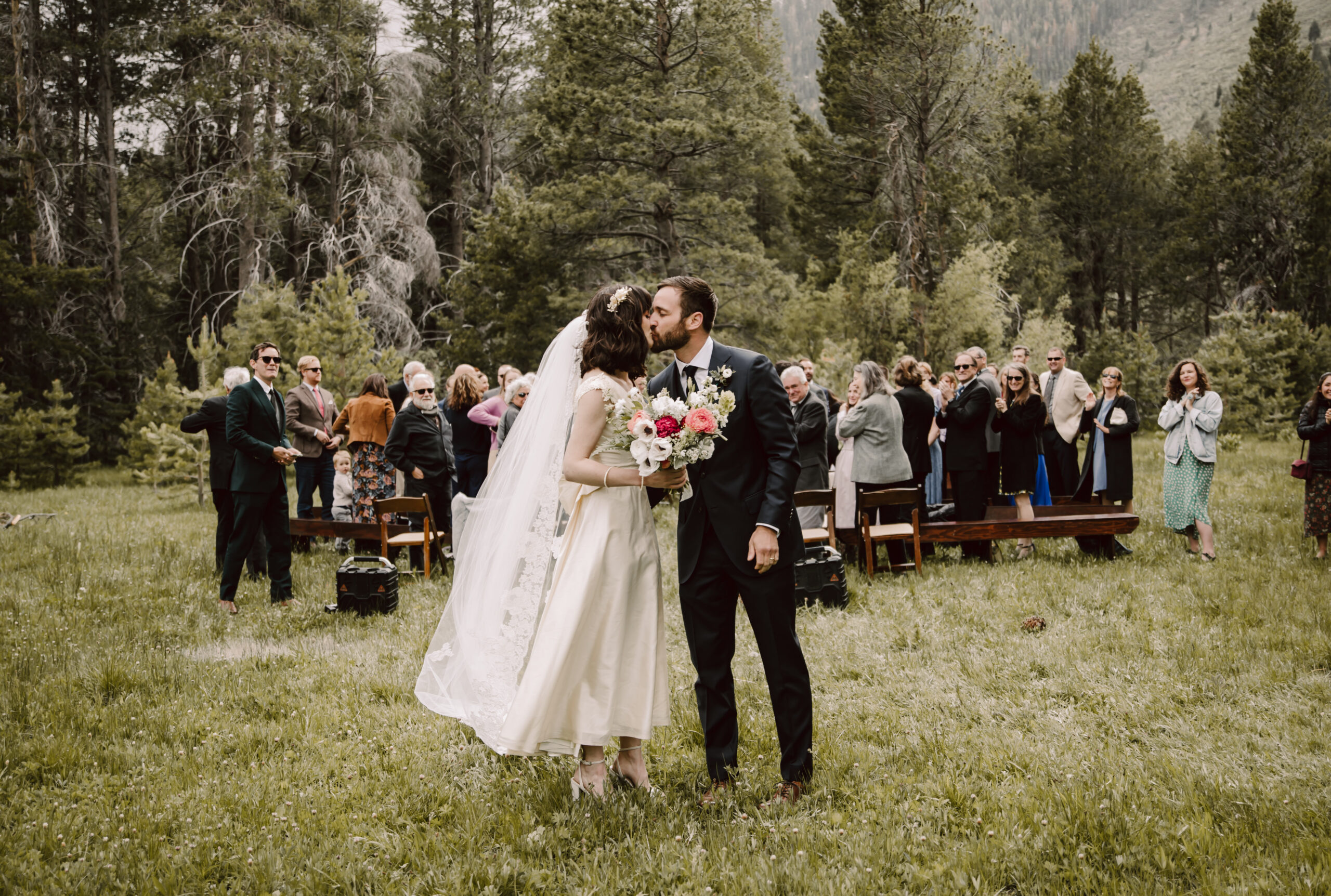 A wedding couple kissing after they walked down the isle for their forest wedding in Lake Tahoe