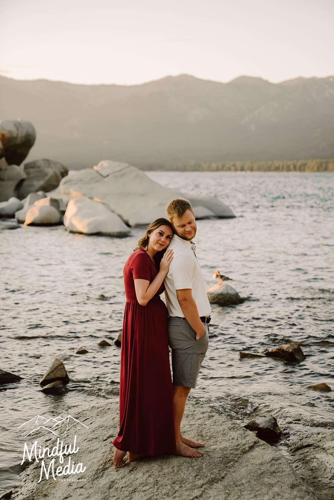 a couple standing on a boulder at Sand Harbor in Lake Tahoe