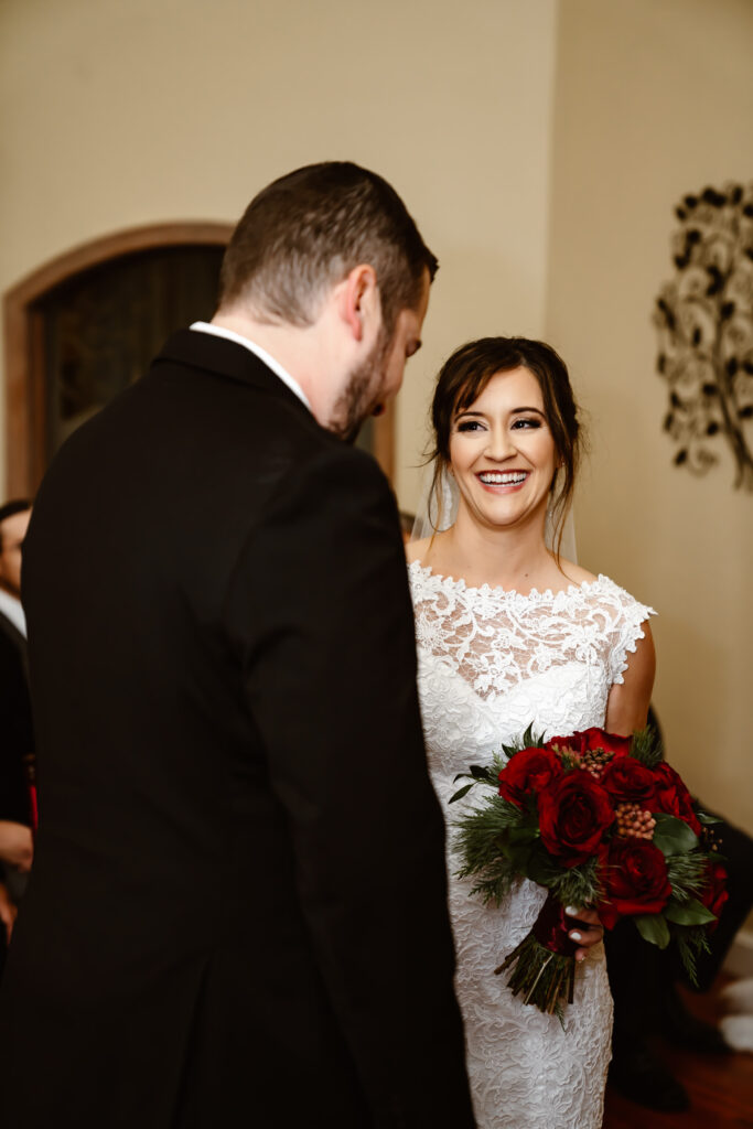 a bride looking at her groom during the wedding ceremony
