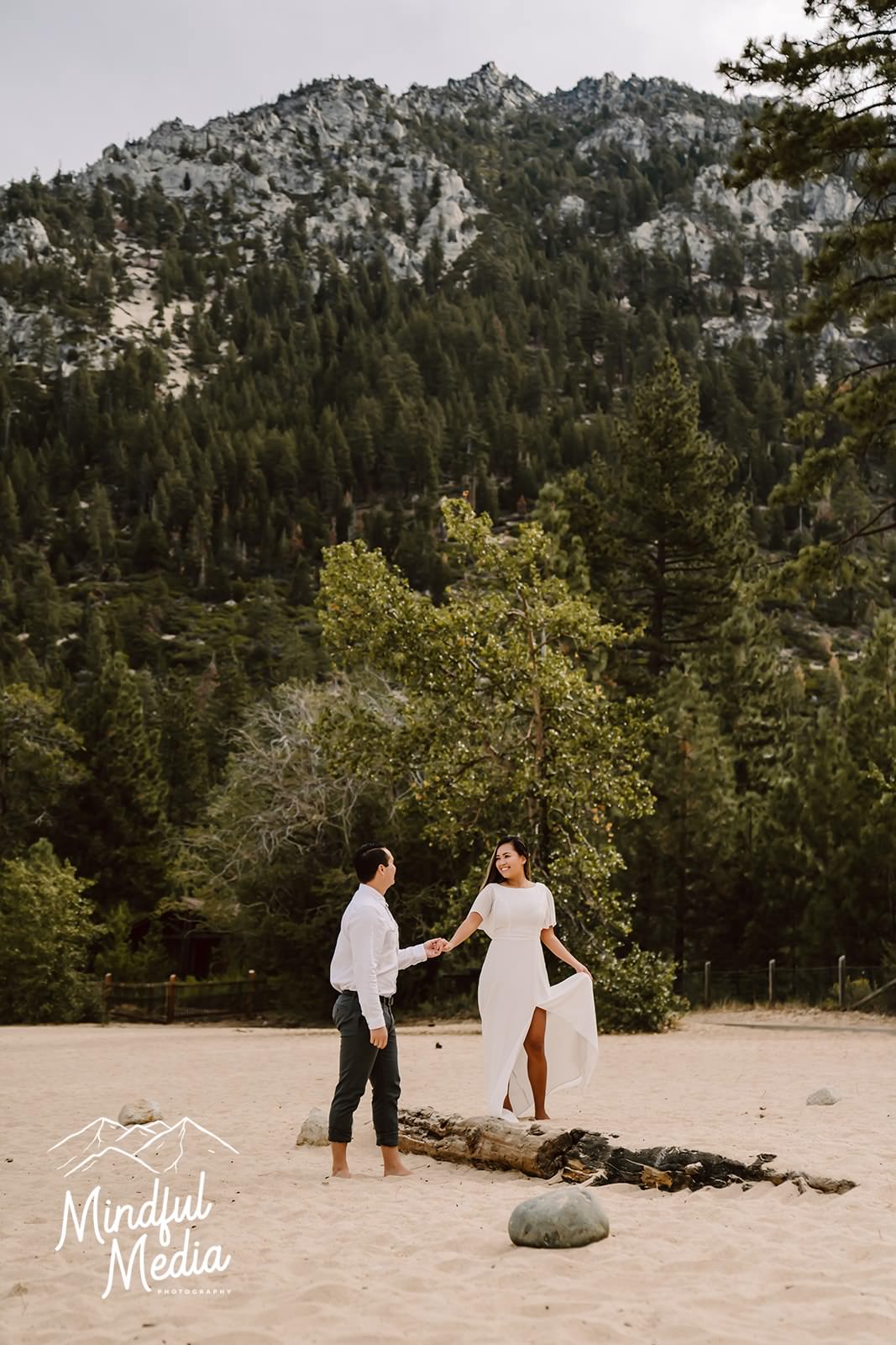 a girl walking on the beach with her fiance