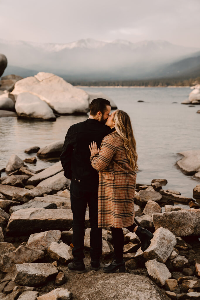 a couple kissing on some rocks in Lake Tahoe