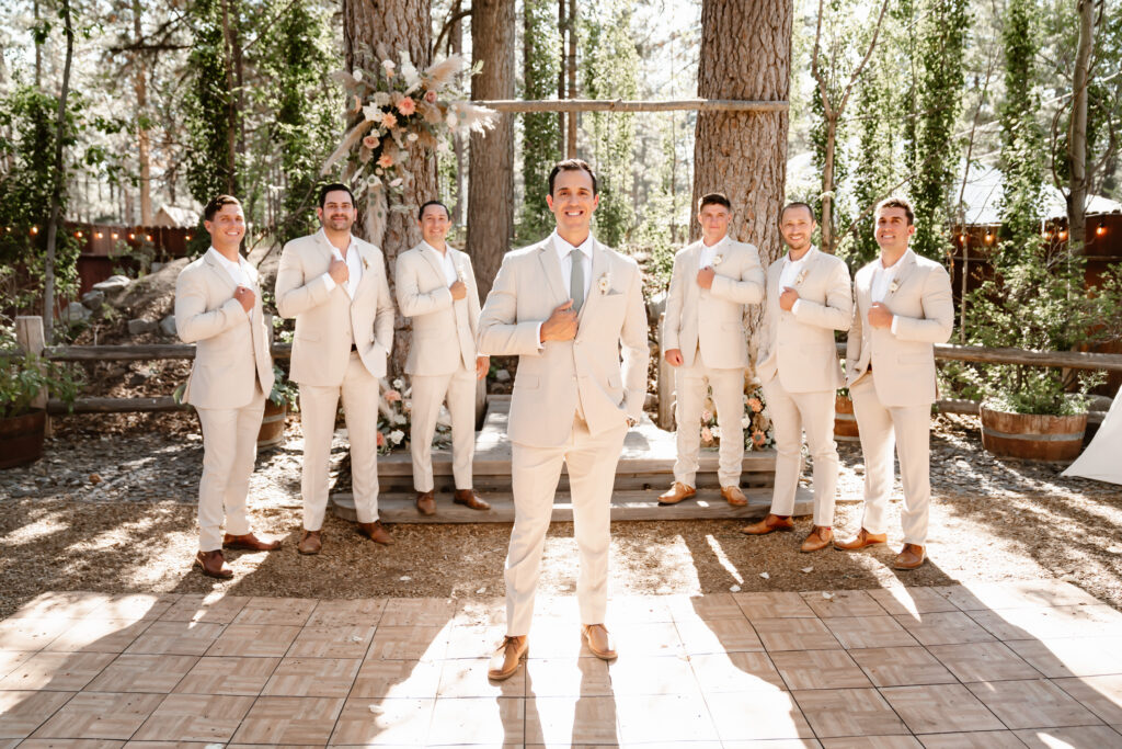 The groom and his groomsmen surrounded by forest