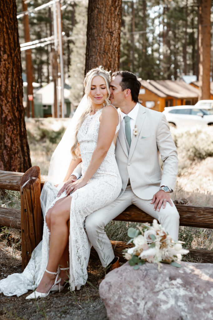 a groom kissing his bride in the forest around Lake Tahoe
