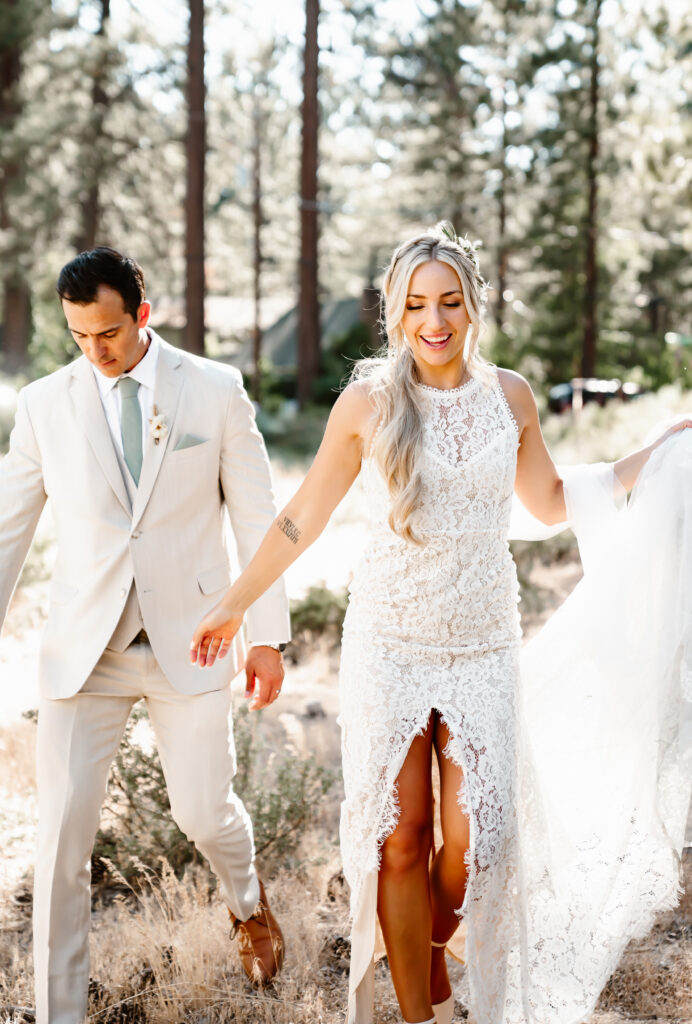 A bride and groom walking through the trees in Lake Tahoe for their wedding day