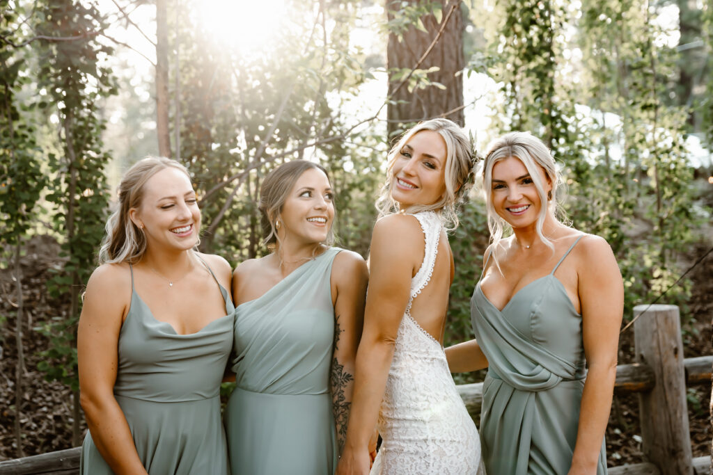a bride and her bridesmaids smiling for the camera