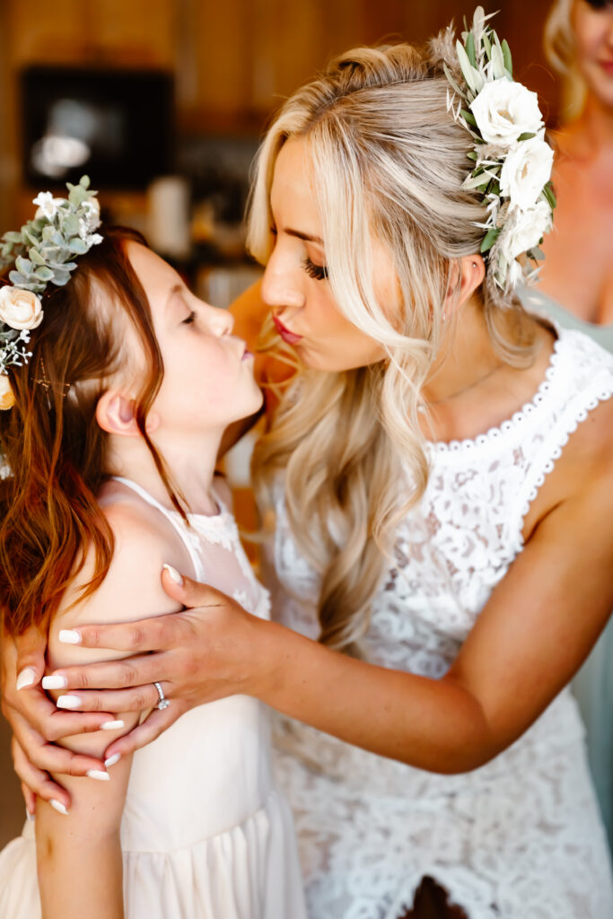 A bride kissing her daughter on her wedding day