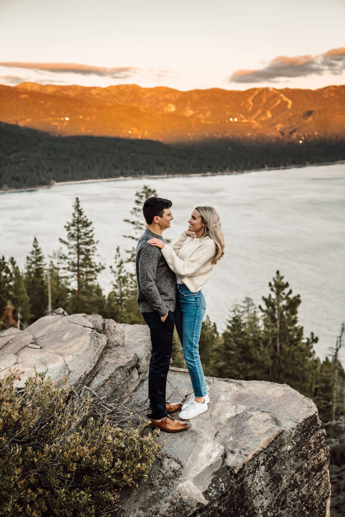 a couple looking at each other in front of alpenglow and the mountains