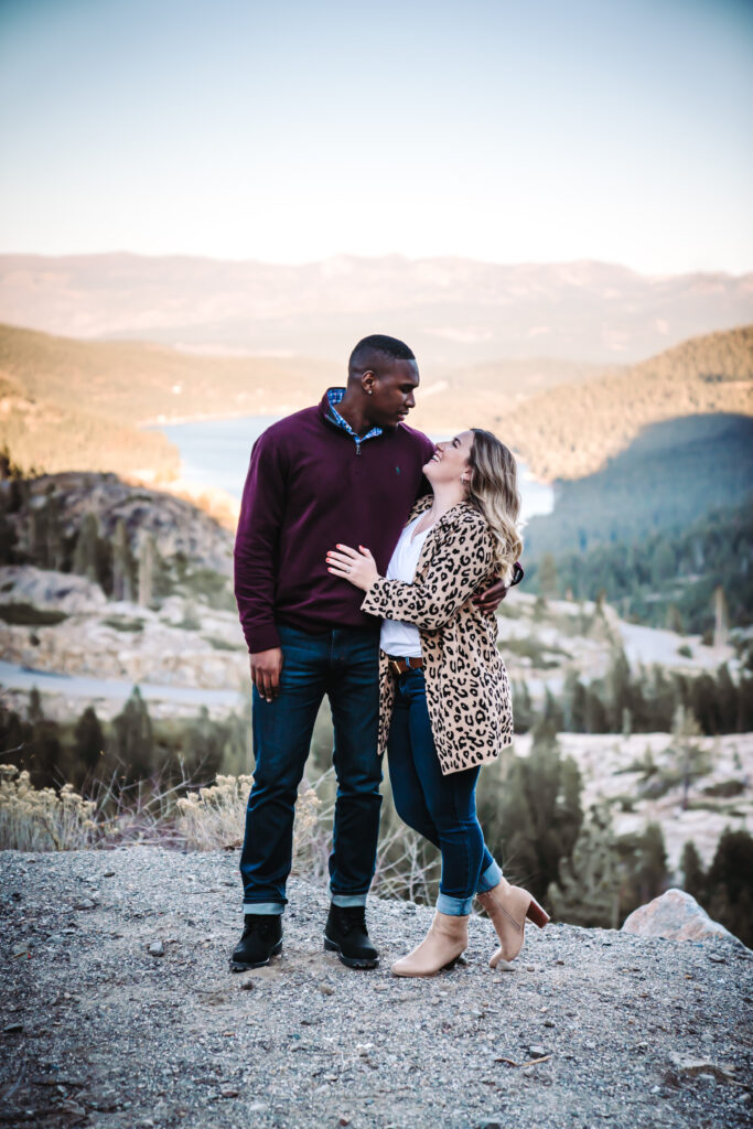 a couple looking at each other  in front of Donner Overlook in Truckee