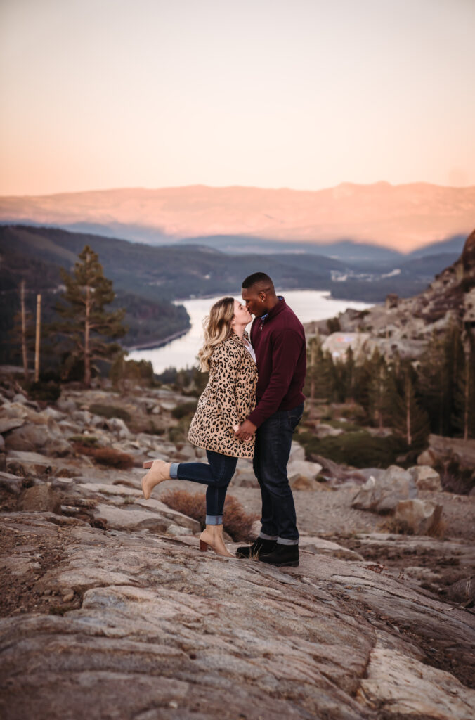 a couple kissing during alpenglow overlooking Donner Lake Overlook in Truckee
