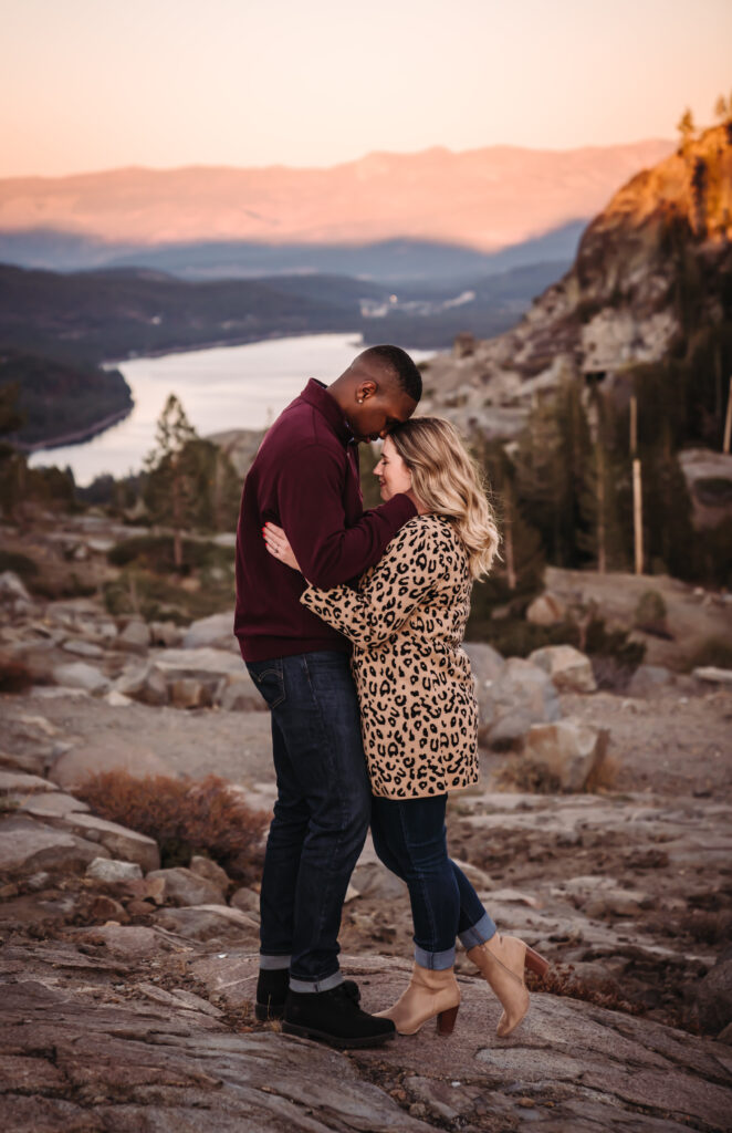 a guy kissing his girl on the top of her head during blue hour in Truckee