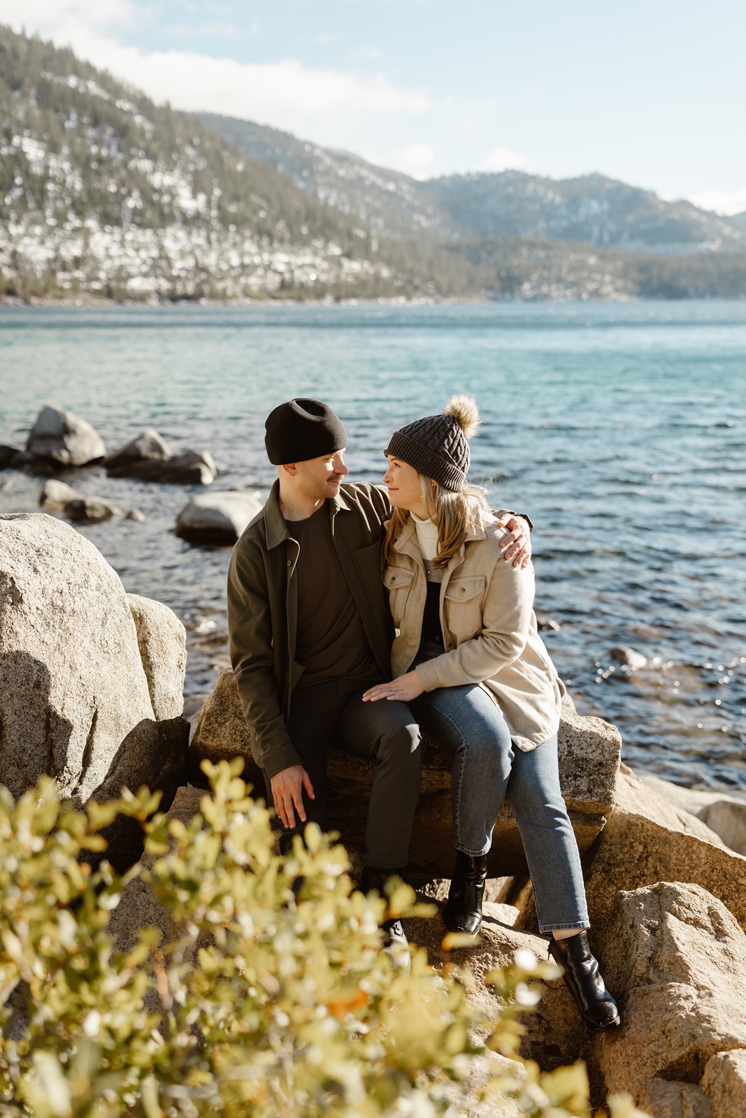 Man and woman wearing winter hats during engagement photos in Lake Tahoe