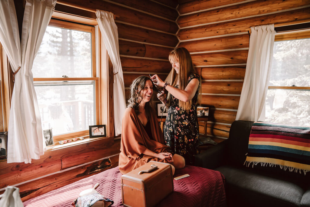 a bride getting ready in a rustic cabin in Northern California for her elopement