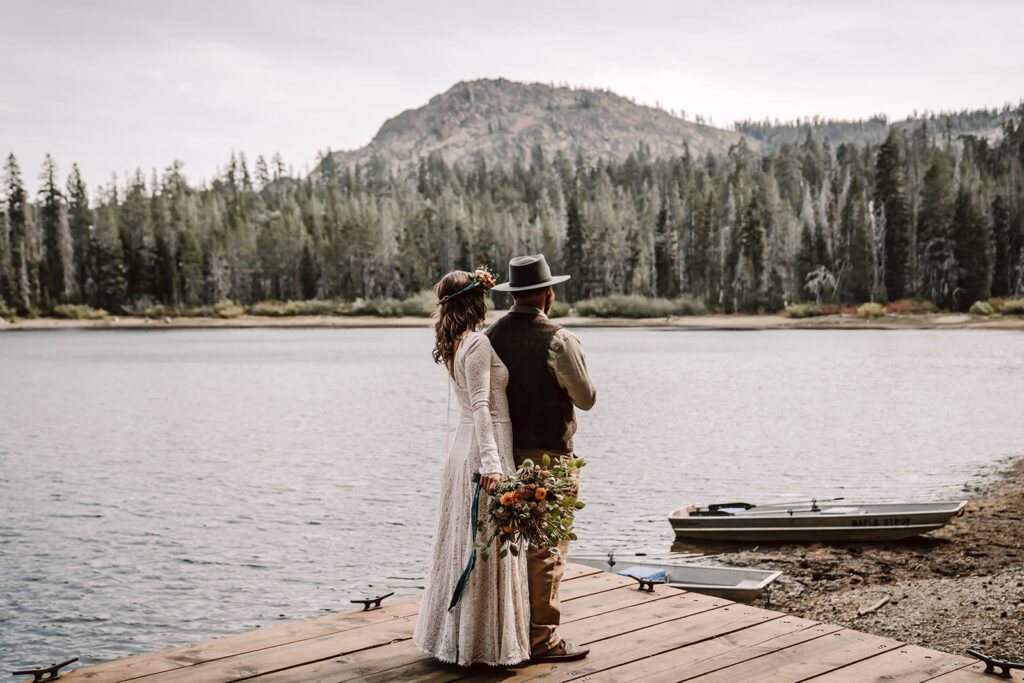 bride and groom doing a first look on a dock overlooking the sierra Nevada Mountains