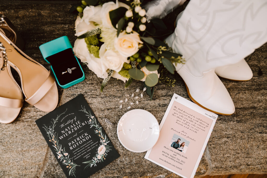 A flat lay of wedding invitations and flowers for getting ready