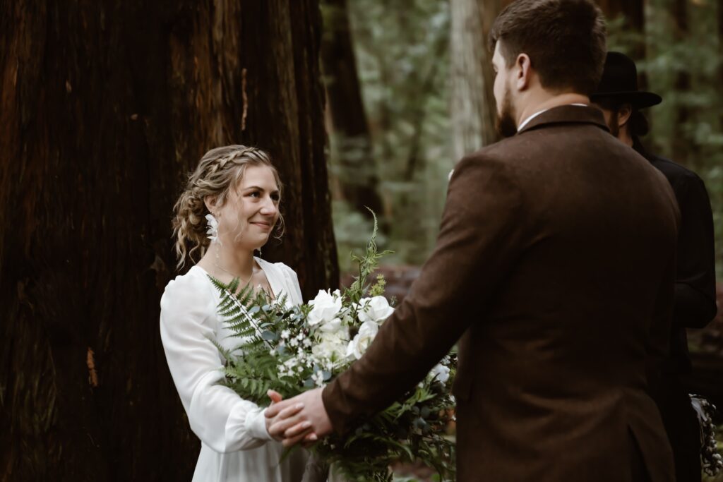 A bride looking at her groom during their elopement in the Redwoods