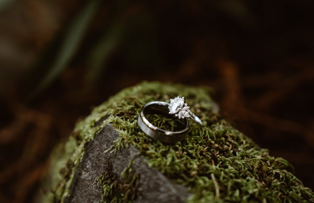a bride and grooms rings sitting in some green moss