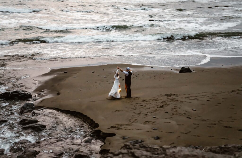 an elopement couple dancing on Enderts Beach in Crescent City surrounded by the ocean