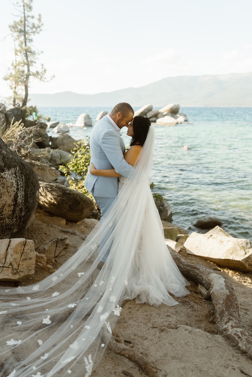 Bride with long veil with groom at Sand Harbor wedding