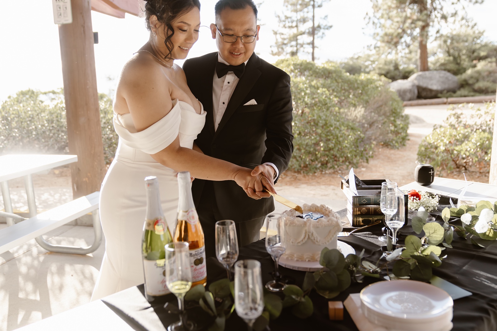 Bride and groom cut their wedding cake at their Sand Harbor wedding reception