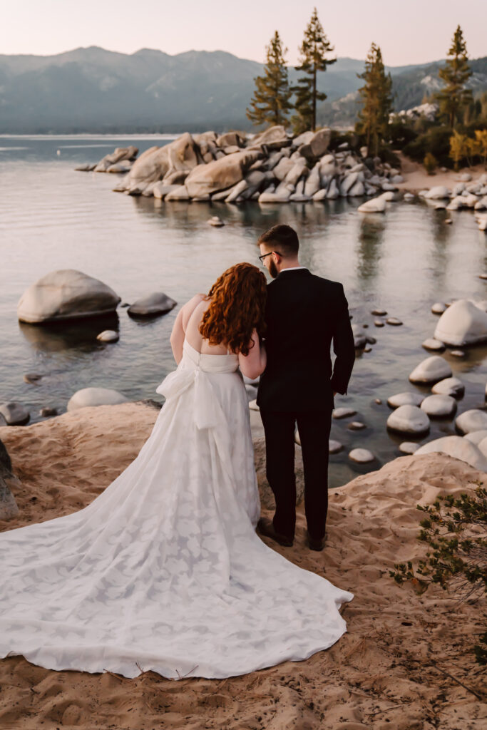 a couple looking out over the water of Sand Harbor for their Lake Tahoe Elopement